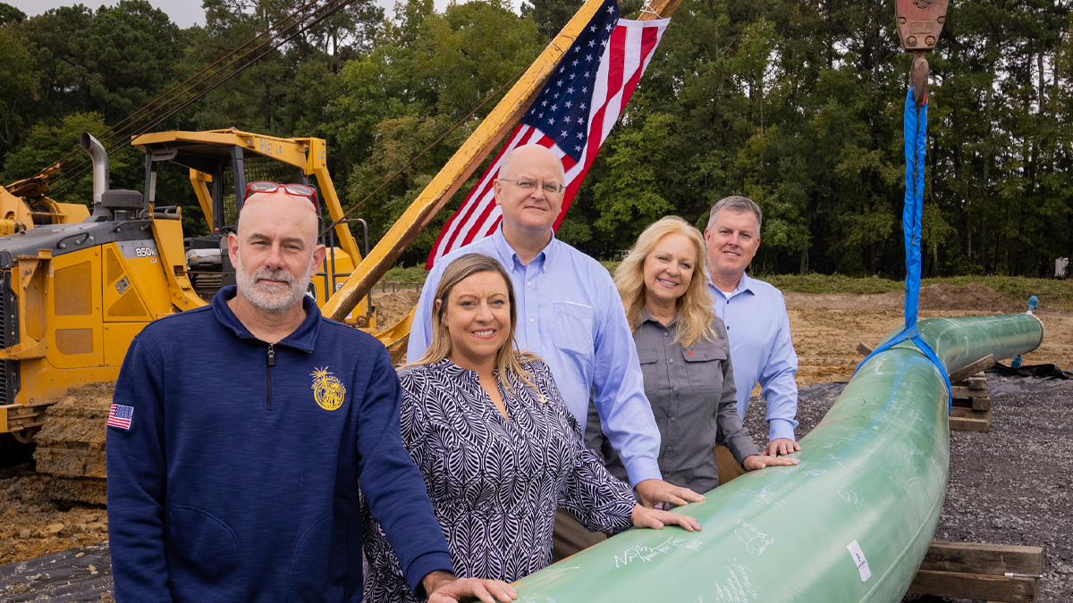 People with their hands on the pipeline
