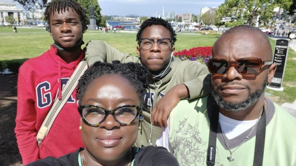 Shola with her husband and two sons.